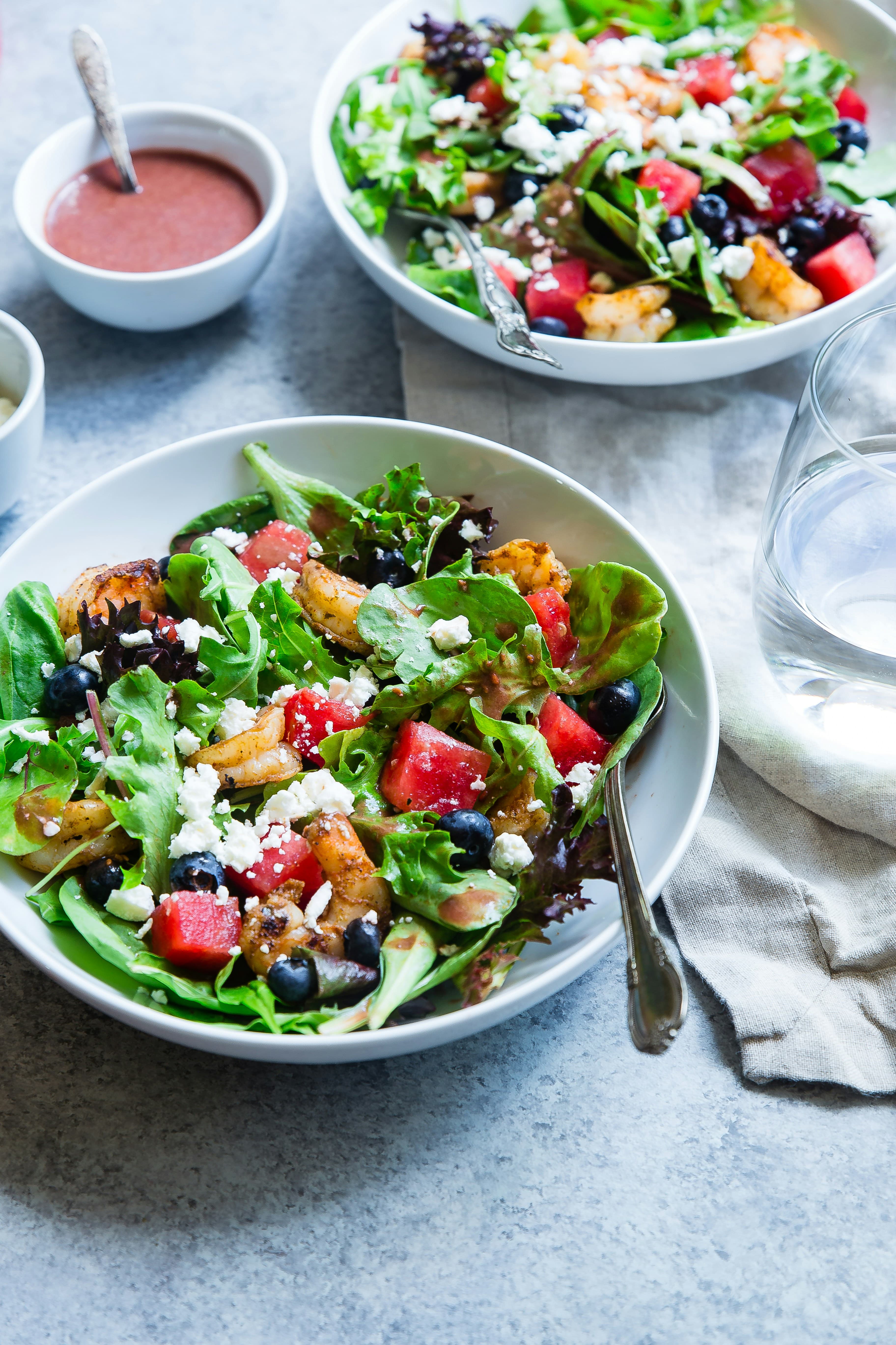 Fresh salad bowls with watermelon, blueberries and greens